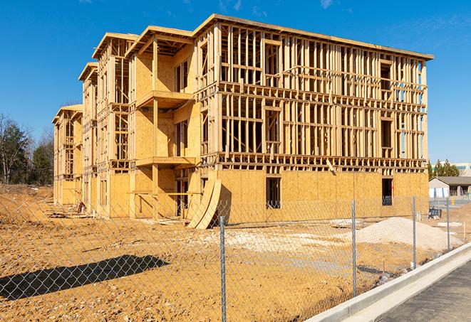 a close-up of temporary chain link fences enclosing a construction site, signaling progress in the project's development in Westchester